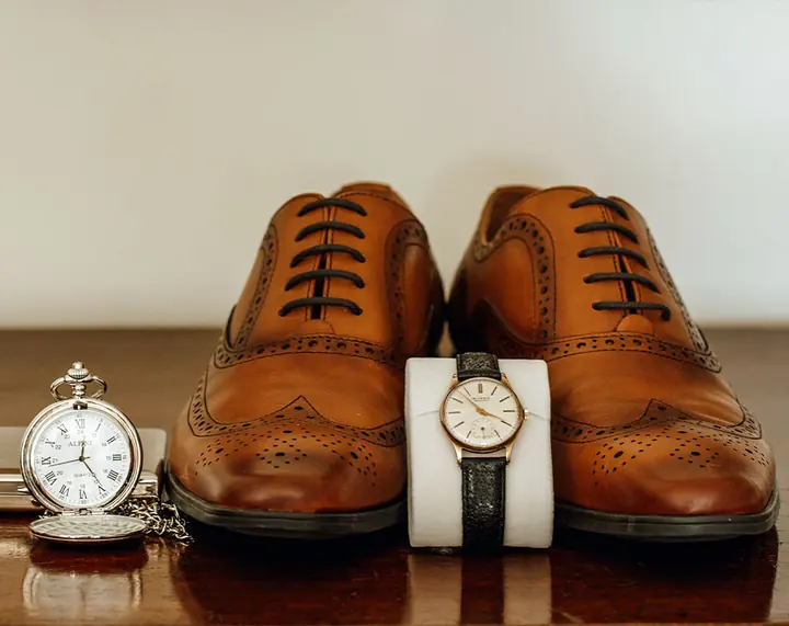 Brown brogues with a pocket watch and wristwatch