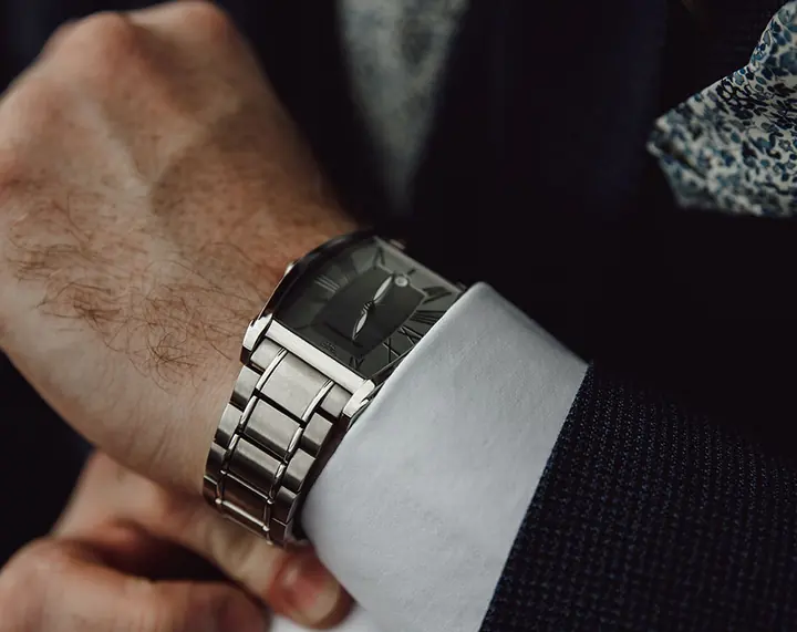 Close-up of a groom fastening his watch