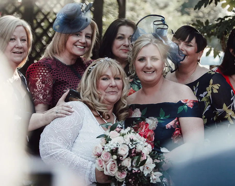 Guests hugging the bride after the ceremony