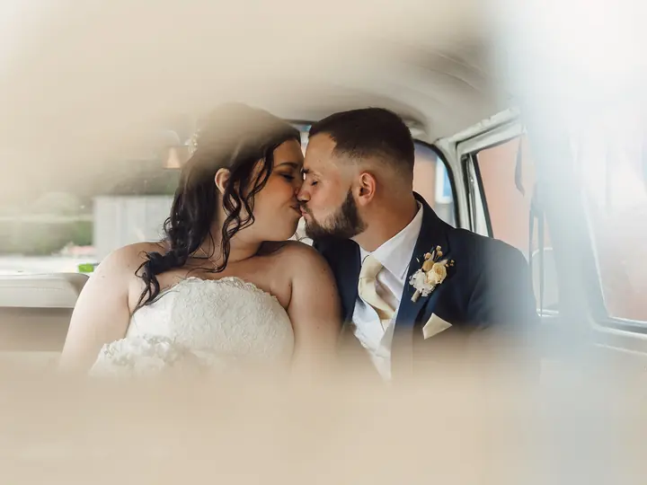 A couple about to kiss, framed through a soft foreground