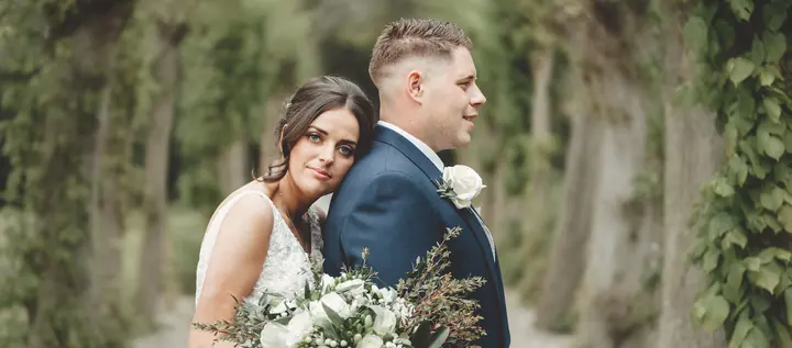 A bride resting her head against her groom