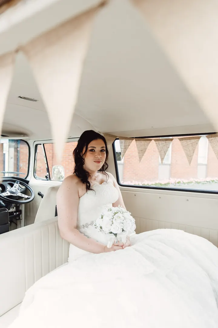 Laura sitting in the camper van with her bouquet