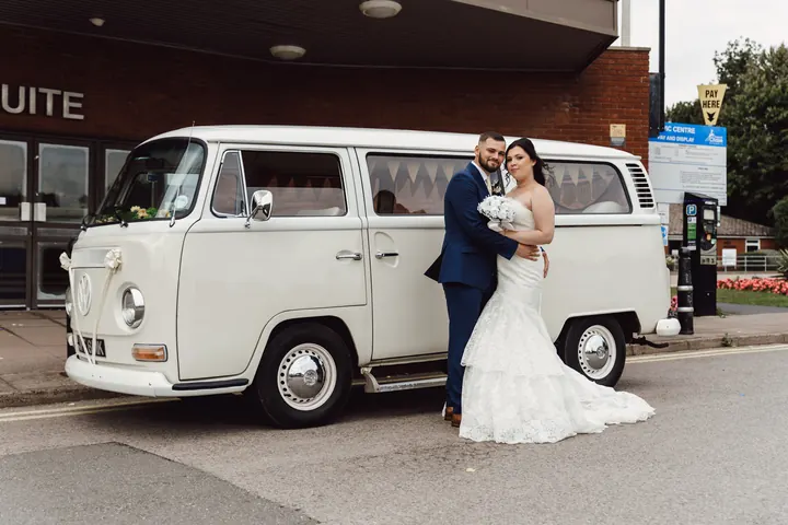 Laura and Owen standing by the camper van