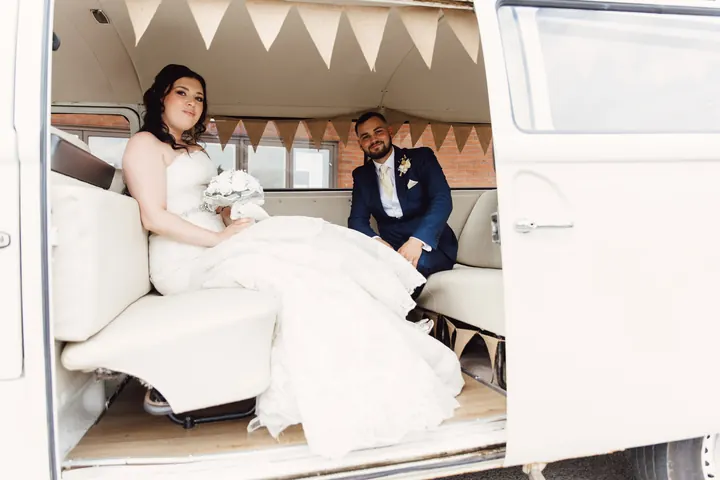 Laura and Owen sitting inside the camper van