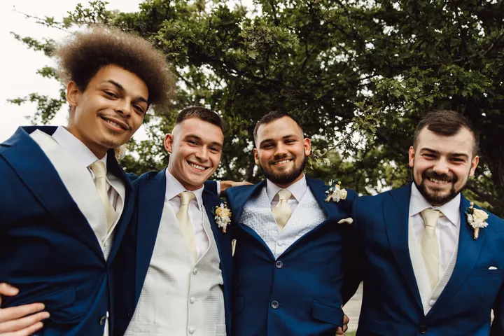 Owen with his groomsmen in navy suits