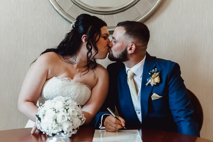 A kiss at the signing table