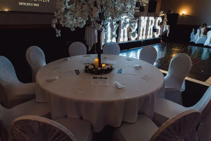Round tables set with white chair covers
