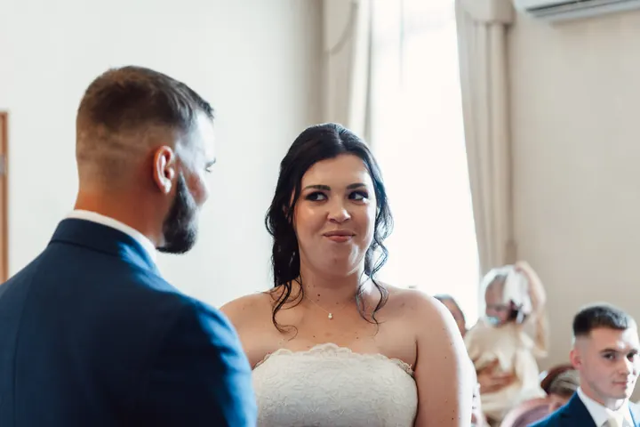 Laura smiling at Owen during the vows