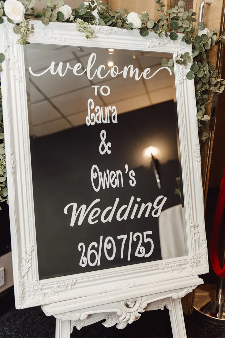 A mirrored welcome sign for Laura and Owen&rsquo;s wedding