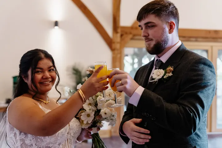 Gloria and Oliver toasting with Bucks fizz