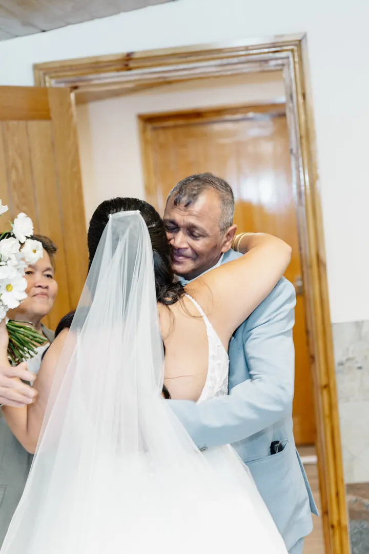 Gloria hugging her dad when he sees her in her dress