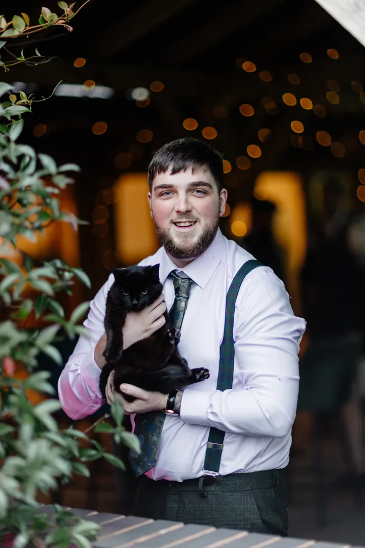Oliver holding the venue&rsquo;s black cat
