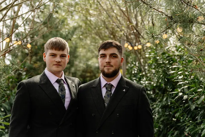Oliver and one of his groomsmen in dark tweed suits