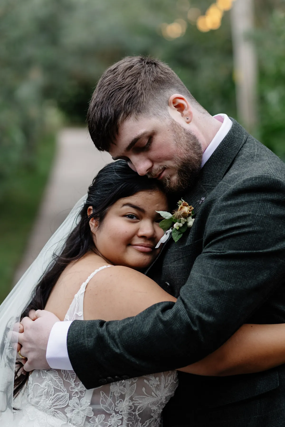 Gloria and Oliver hugging on their wedding day at Coton House Farm