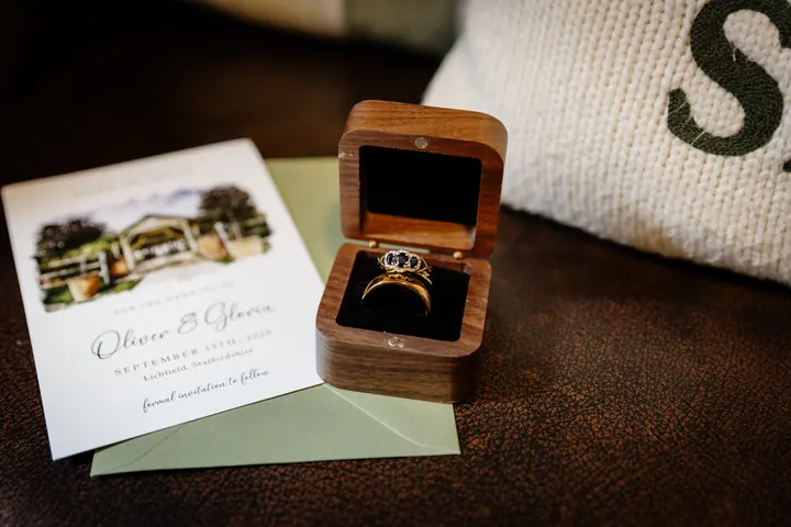 Illustrated wedding stationery with the wedding rings in a wooden box