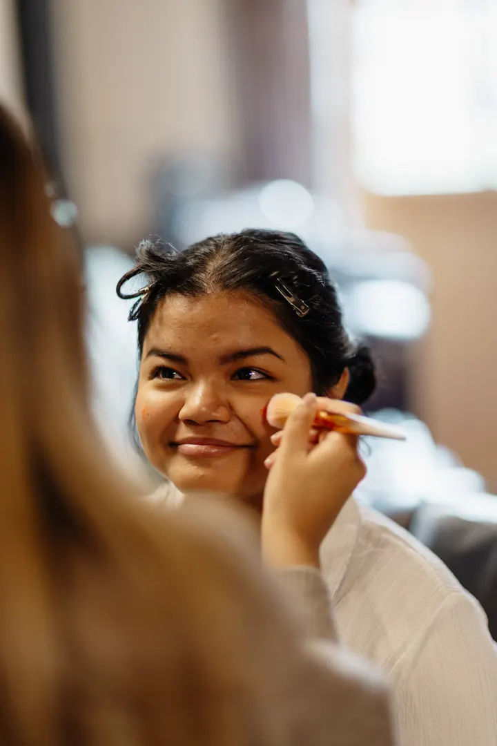 Gloria smiling as her make-up is finished