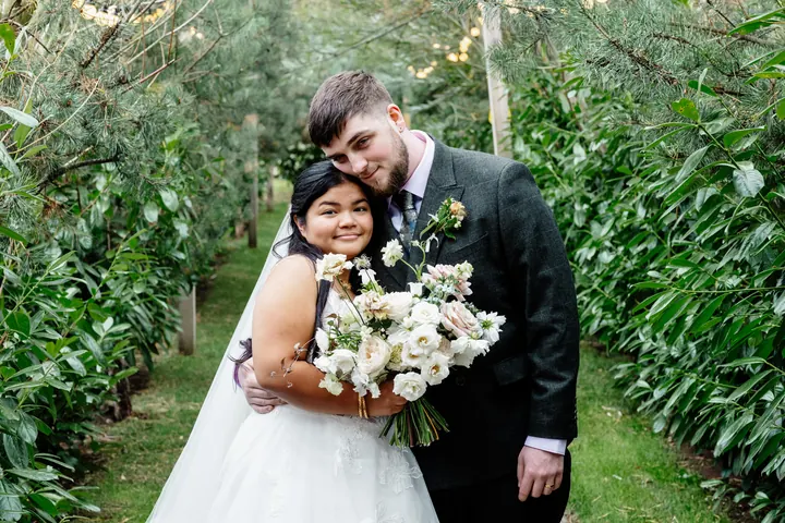 Gloria and Oliver hugging in the pine walk