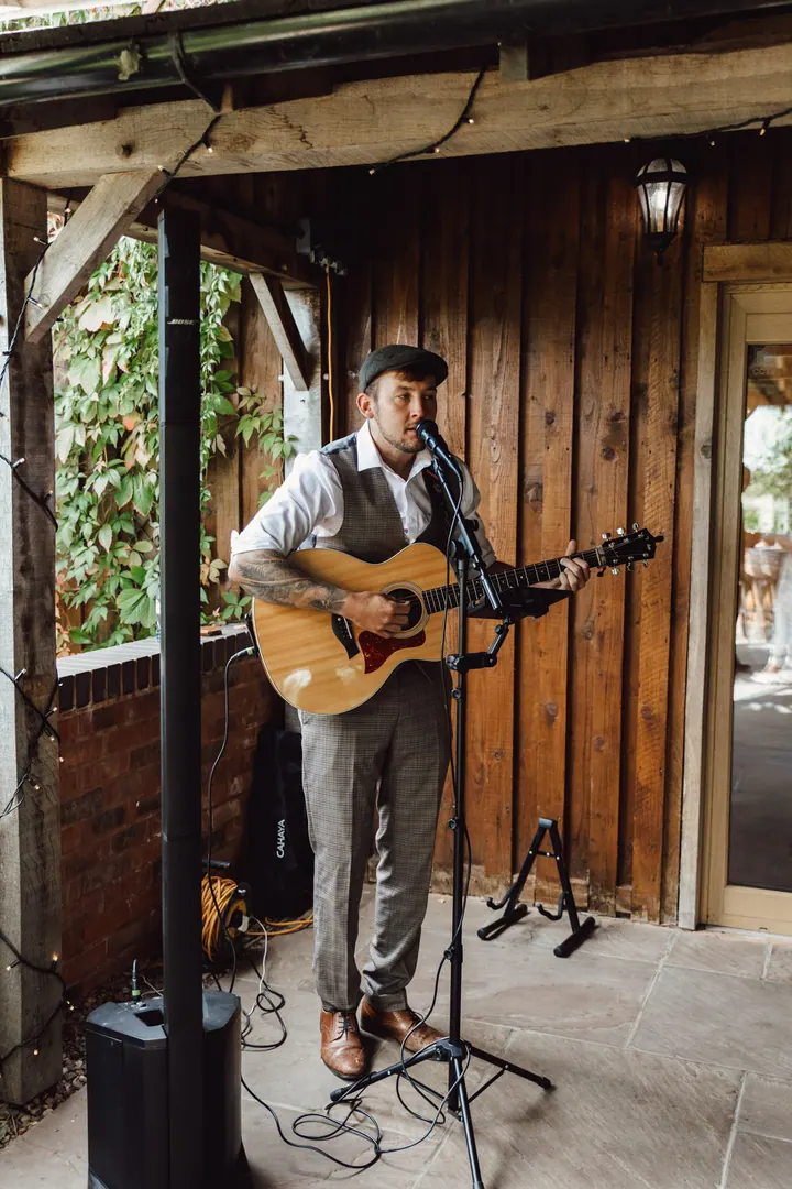 An acoustic singer playing on the patio