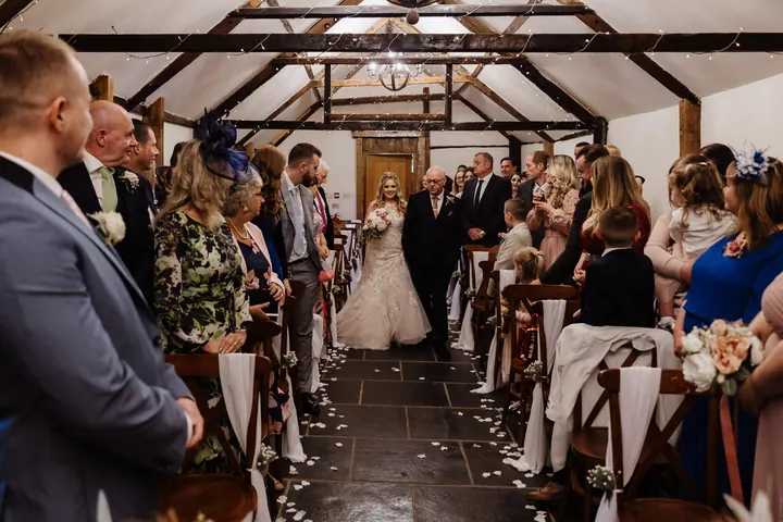 Natasha walking down the aisle of the Old Dairy Barn
