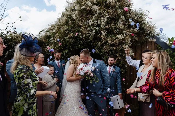 Guests throwing confetti over Natasha and Ryan