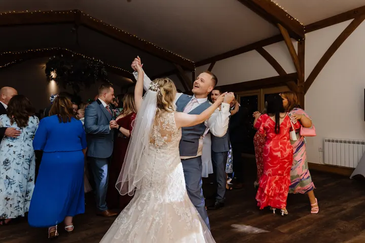 Guests filling the dancefloor in the oak barn