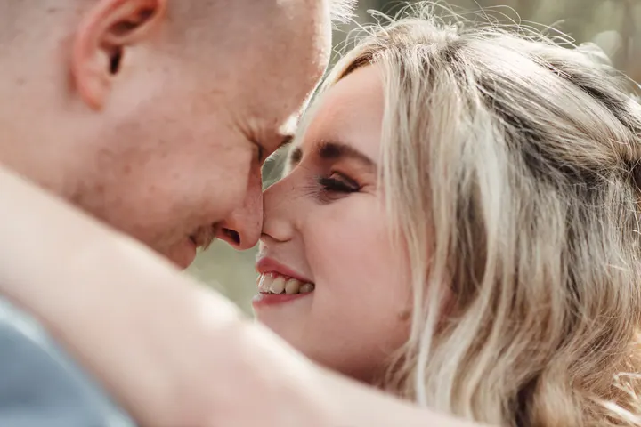 A close-up of the couple nose to nose, laughing