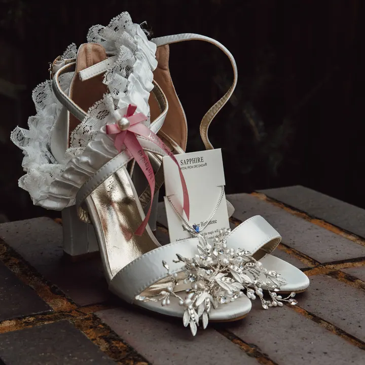 Bridal sandals, a garter and a sapphire birthstone necklace