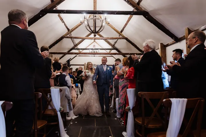 The newlyweds walking back down the aisle