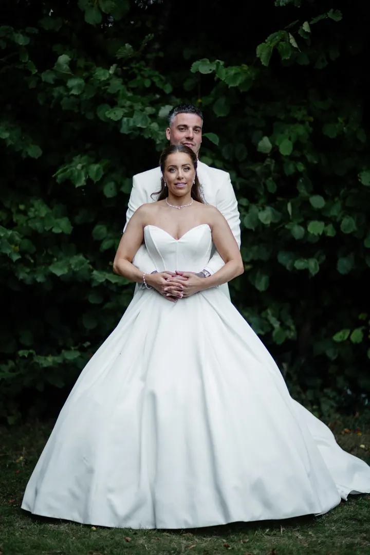 Hayley&rsquo;s full ballgown against the dark woodland
