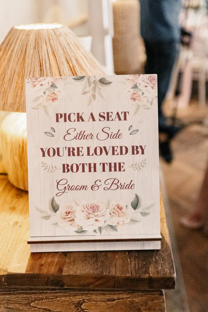 A sign reading Pick a seat, either side, you&rsquo;re loved by both