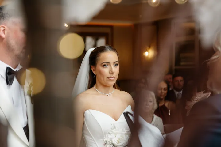 Hayley seen through the blossom during the ceremony