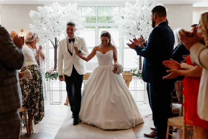 The newlyweds walking back down the aisle