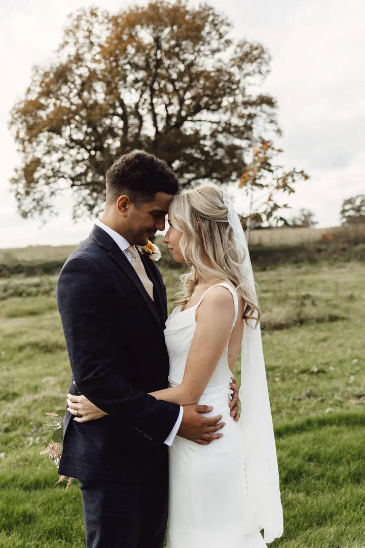 Cicely and Nathan beneath a big autumn oak in the field