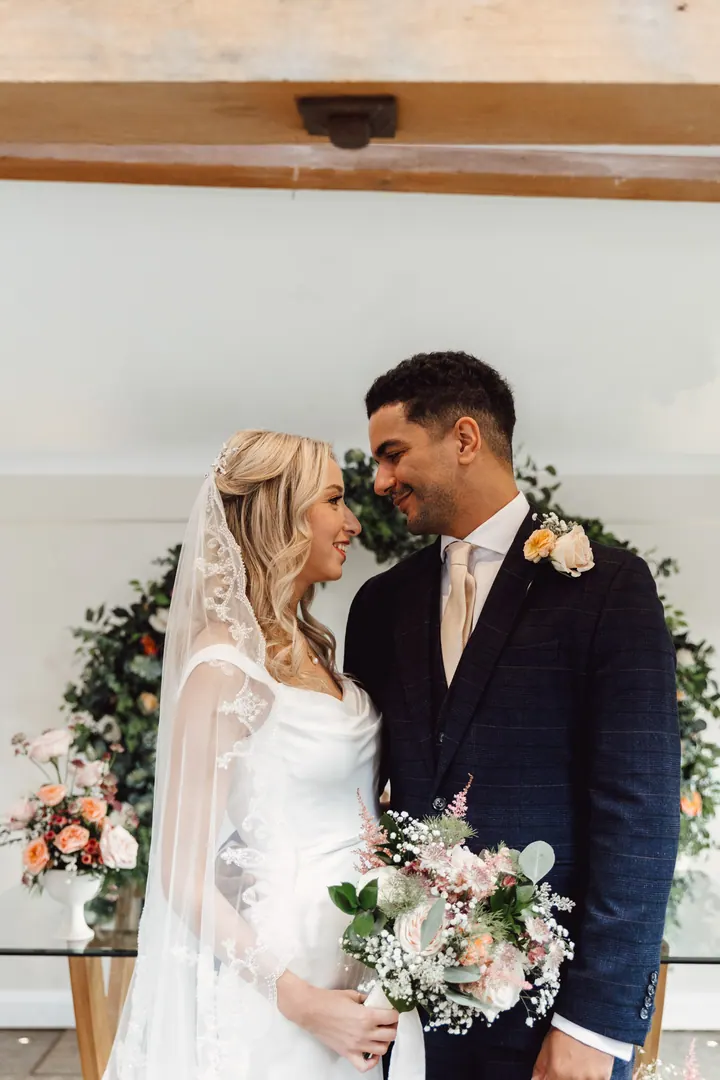 Cicely and Nathan cuddled up in front of the floral hoop