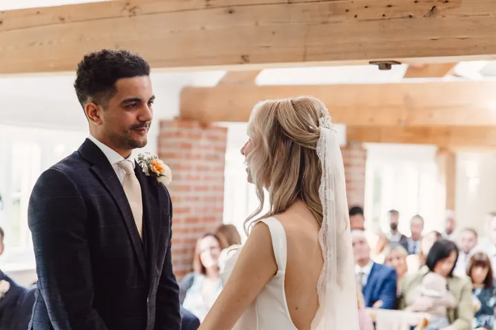 Nathan grinning at Cicely during their vows