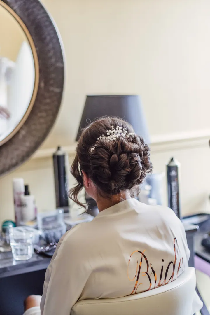 The back of Hannah&rsquo;s Bride robe as her veil is fitted