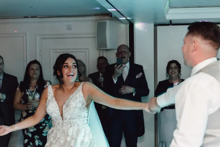 Hannah laughing as Harry spins her on the dancefloor