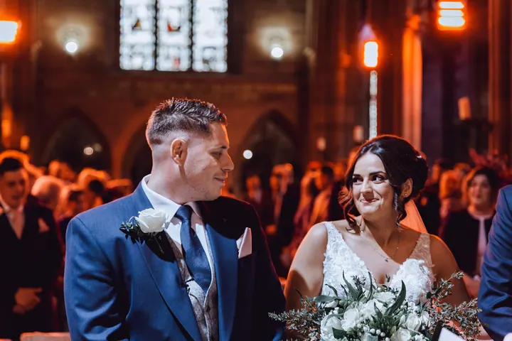 Harry grinning at Hannah during the ceremony