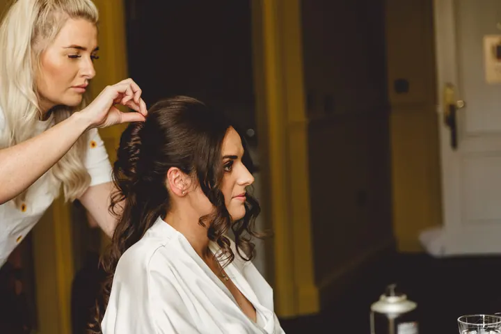 Hannah having her hair styled in the bridal room