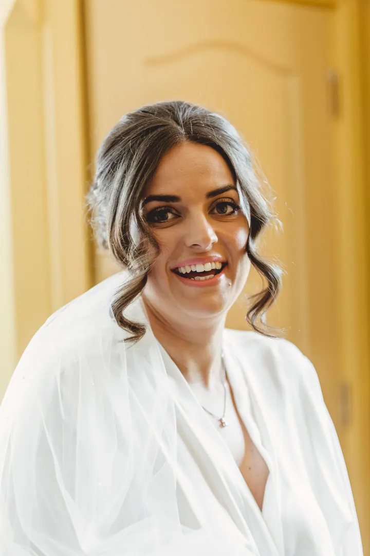 Hannah laughing in her robe before getting into her dress