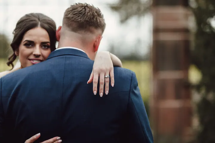 Hannah&rsquo;s hand and wedding ring resting on Harry&rsquo;s back