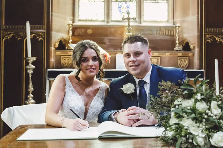 Harry and Hannah signing the register