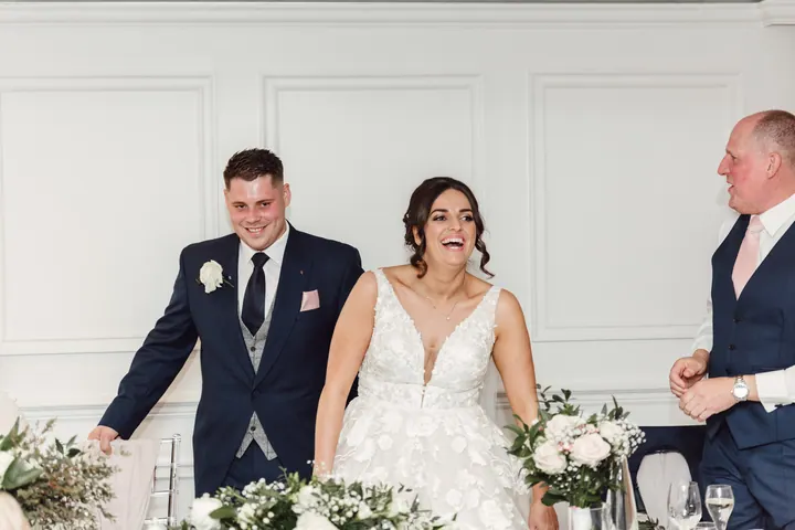 The couple laughing during the speeches