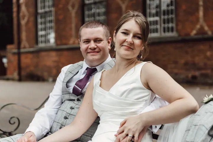 The couple sitting together on a bench