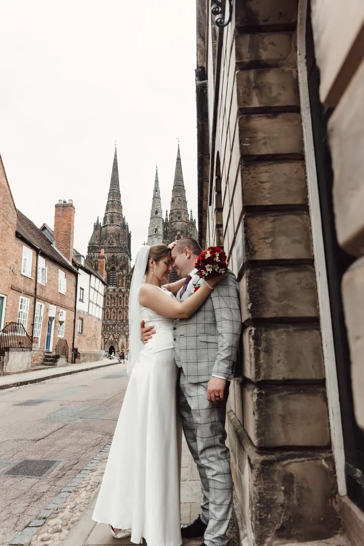Aleks and Jamie in a street of the Cathedral Close, spires behind