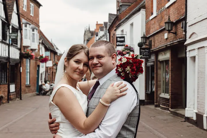The couple hugging and smiling in the street