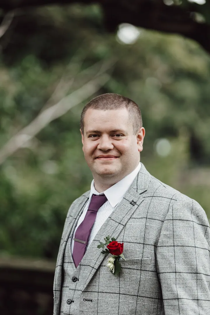 A portrait of Jamie in his grey check suit