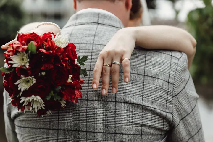 Aleks&rsquo;s hand and ring resting on Jamie&rsquo;s shoulder