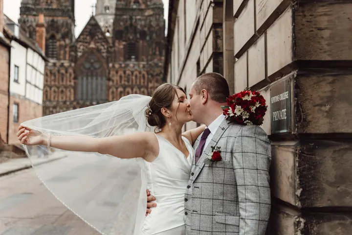 Aleks&rsquo;s veil caught by the wind as she kisses Jamie