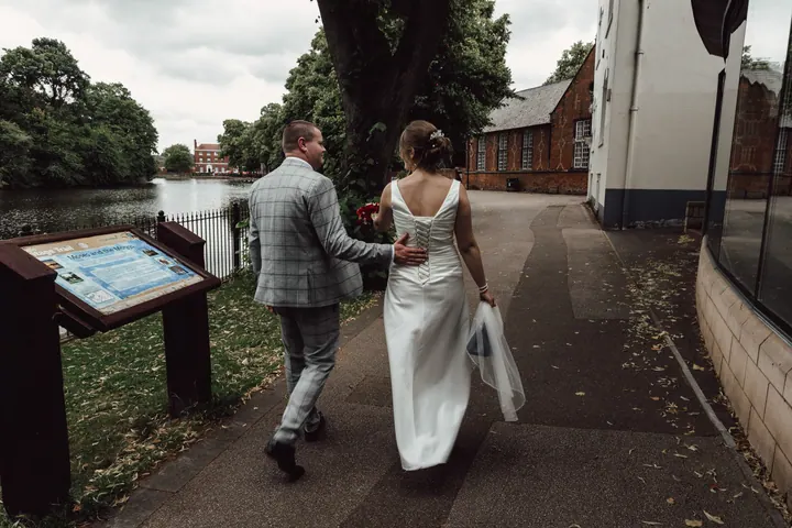 The couple walking away along the path, hand in hand